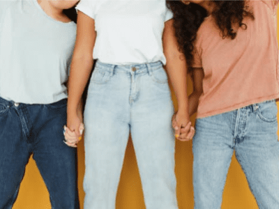Three faceless women standing holding hands